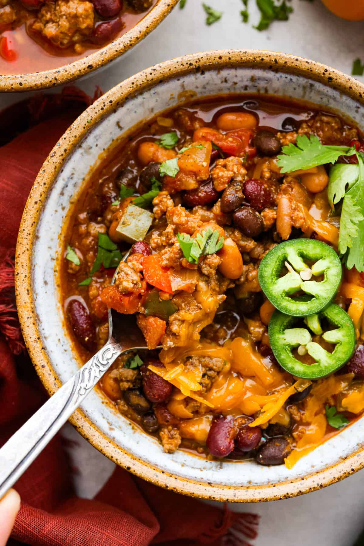 Closeup of the pumpkin chilli, topped with cheese and jalapenos.