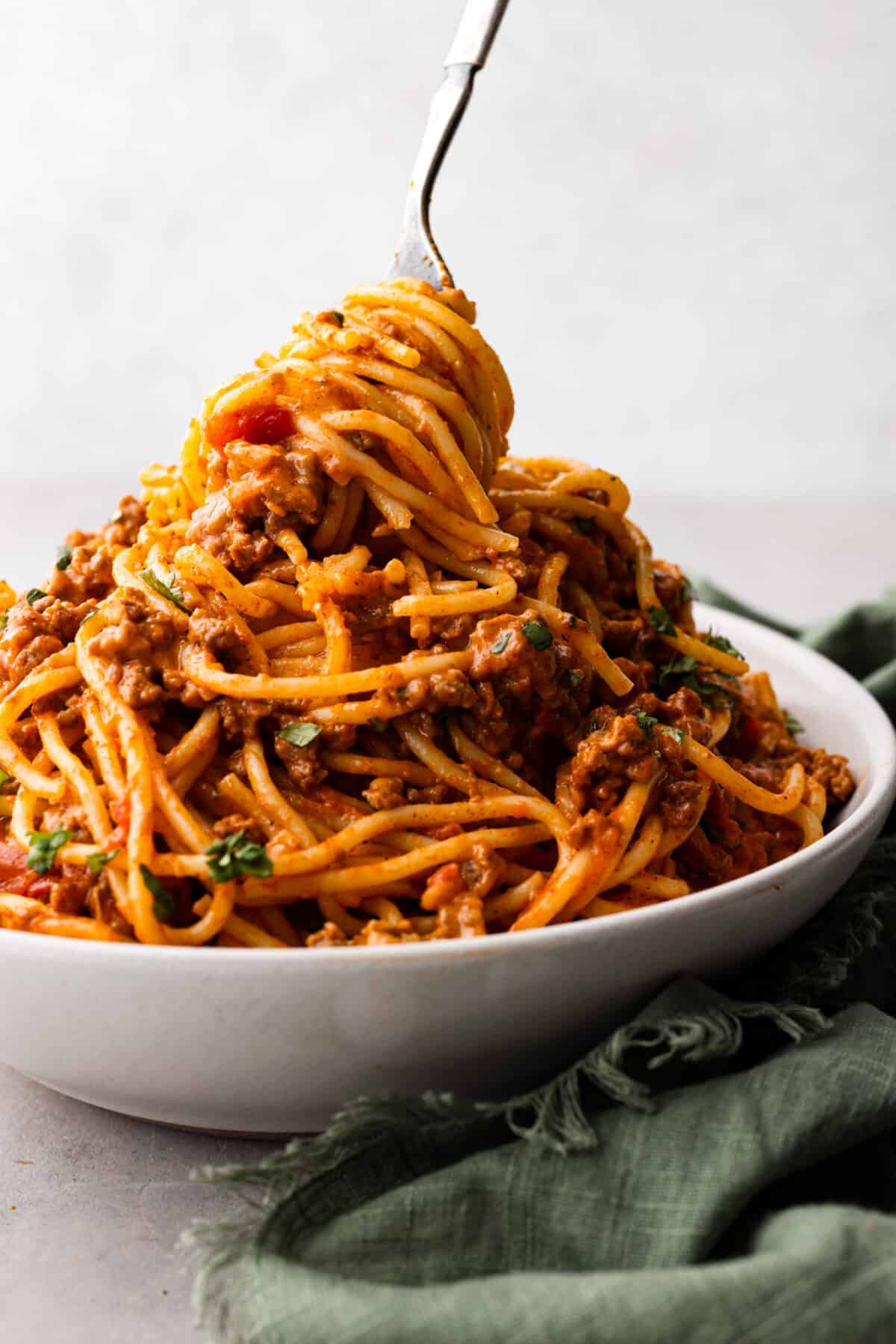 A white bowl filled with taco spaghetti.