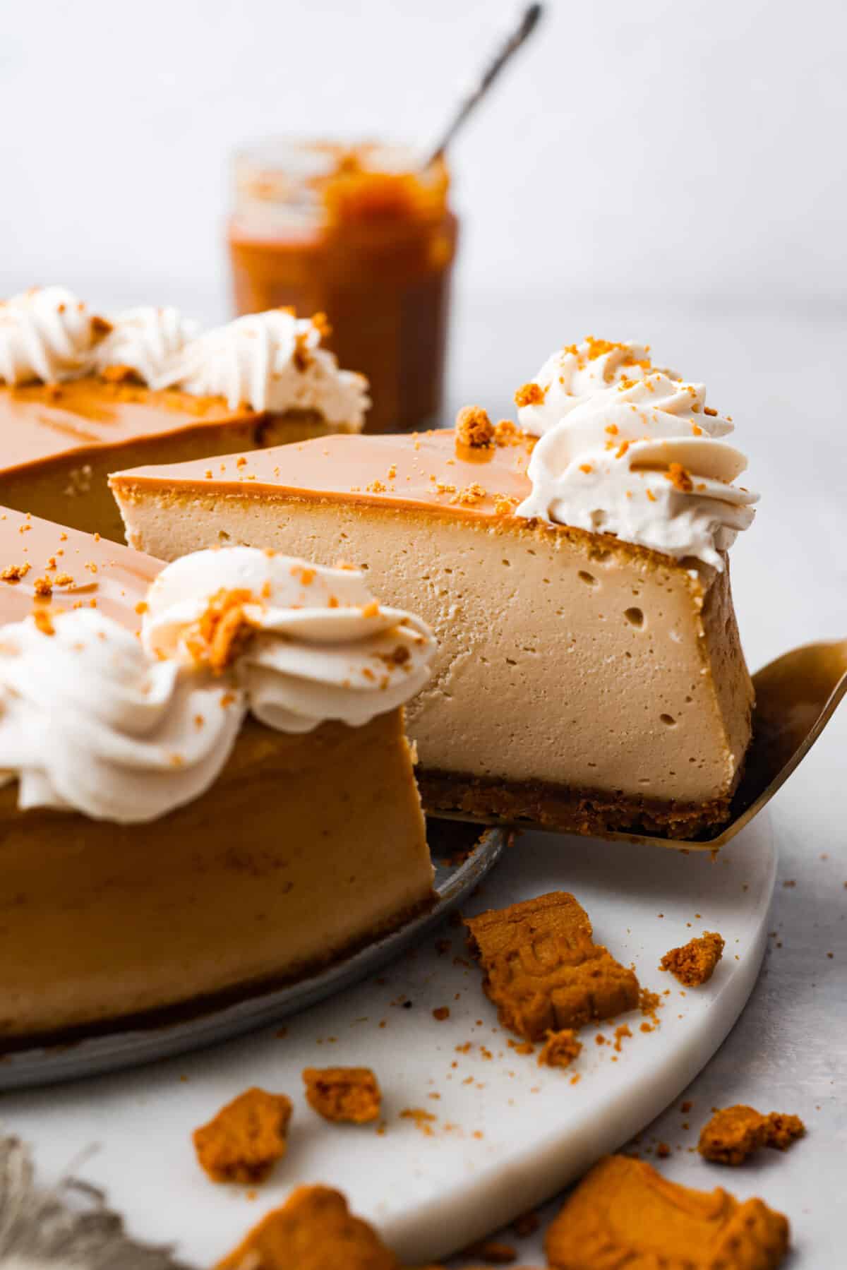 Closeup of a slice of Biscoff cheesecake on a metal cake spatula.