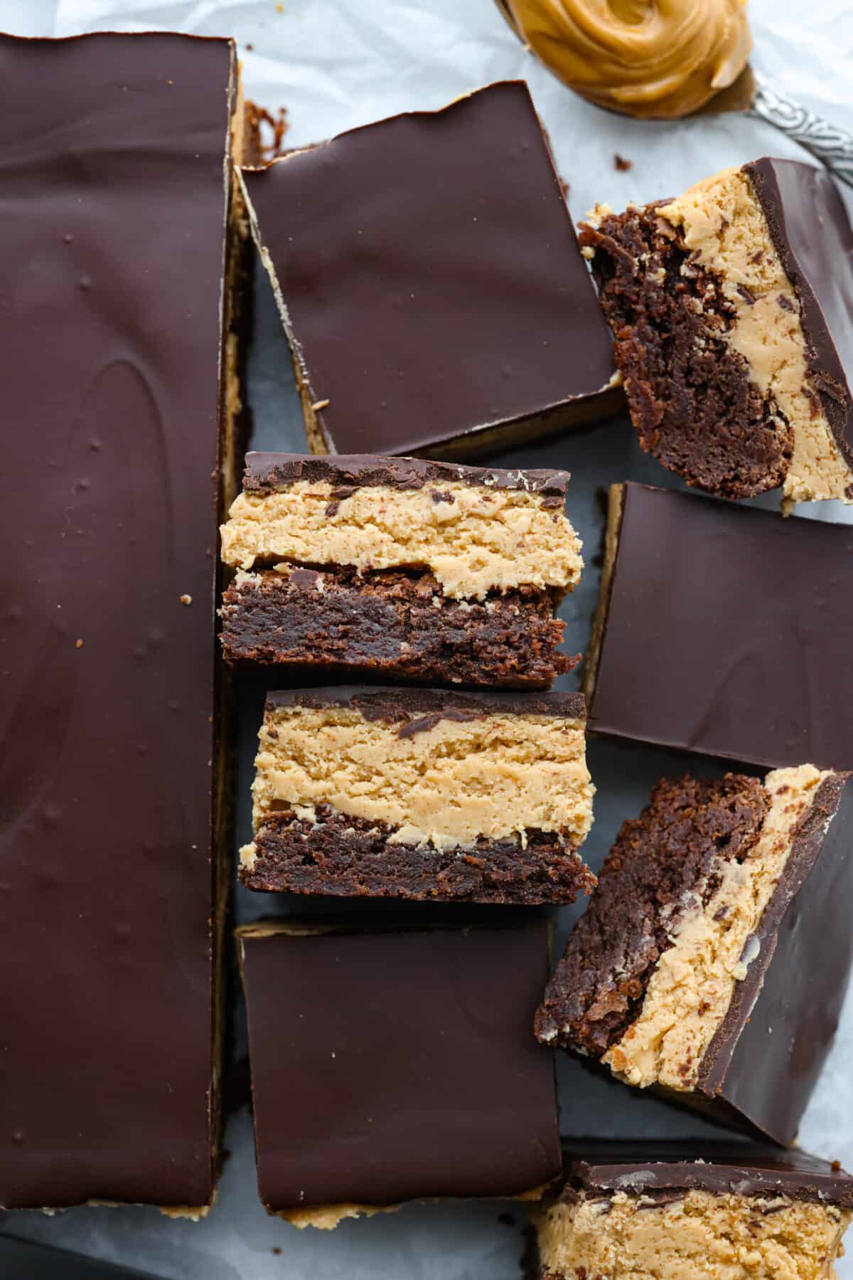 Top view of buckeye brownies cut into squares on parchment paper.