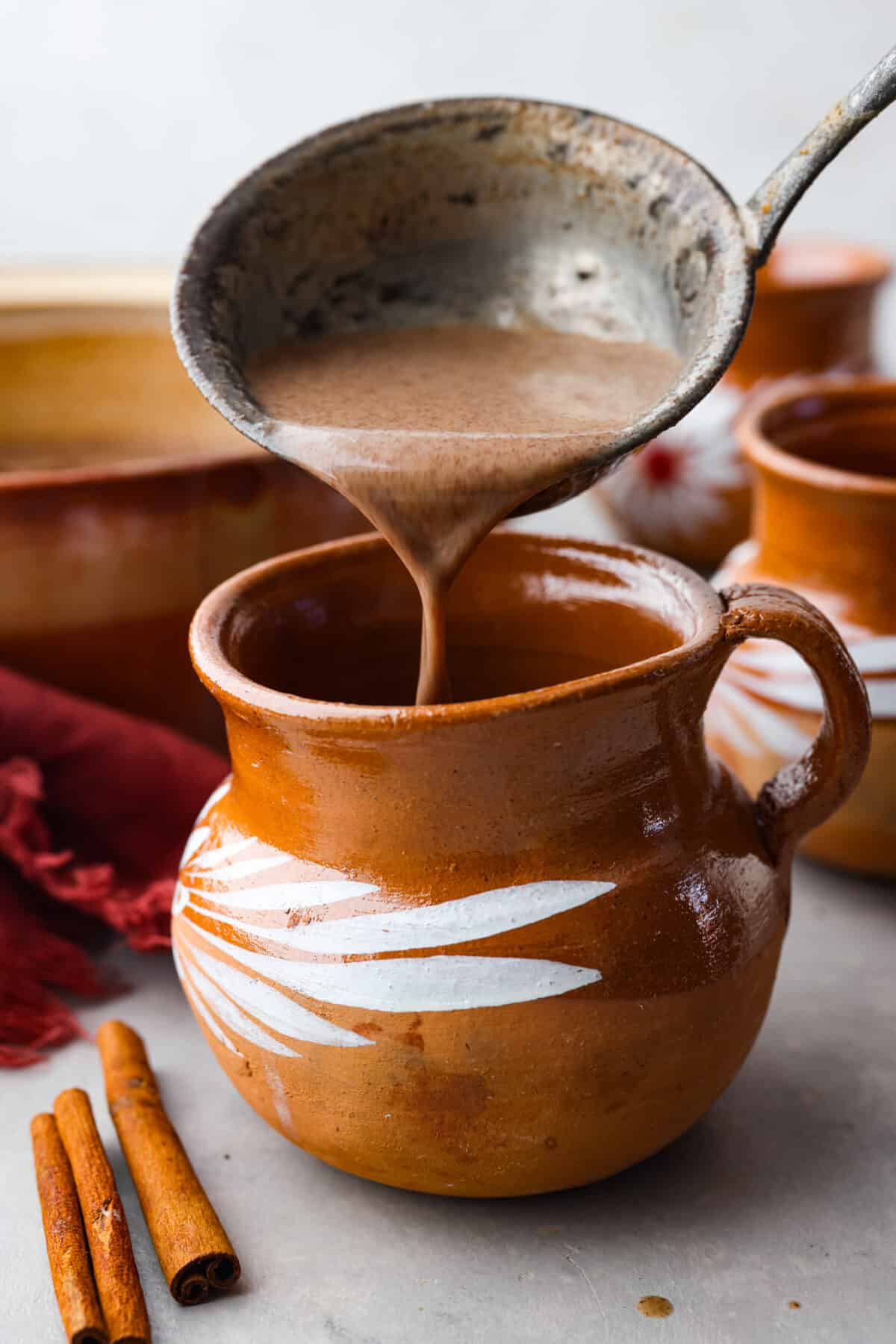 Pouring the beverage into a mug.