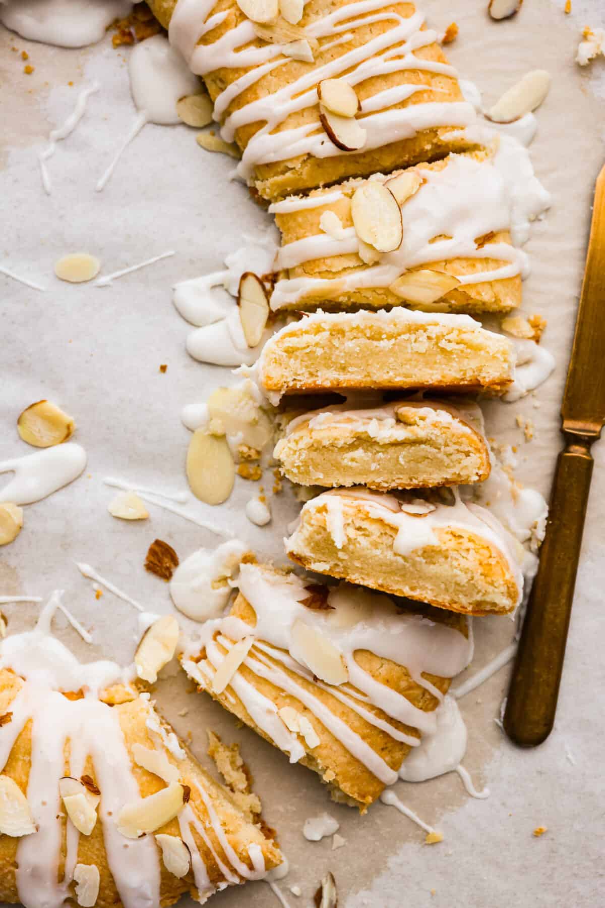 A close up of a Danish Kringle that has been cut into slices. 