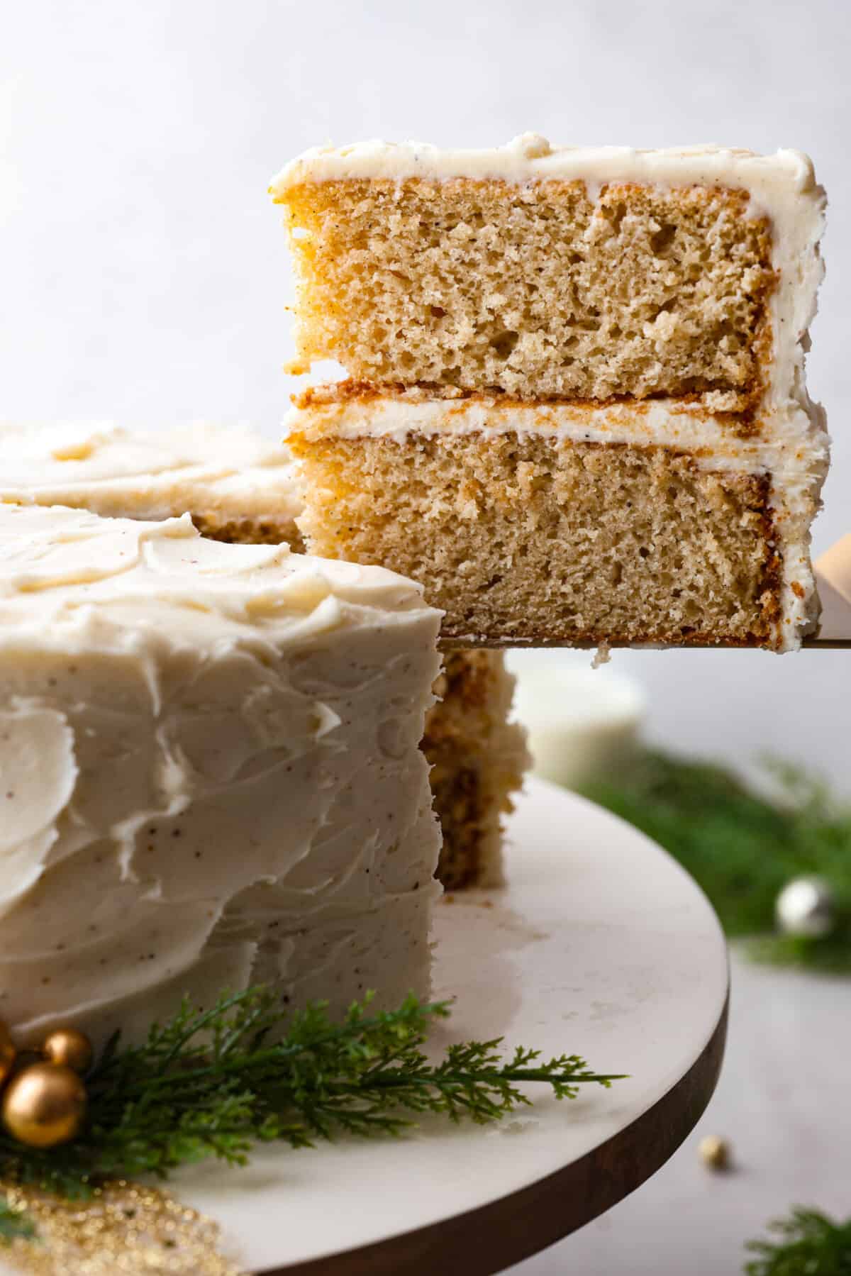 Close side view of a slice of cake lifting from the cake.