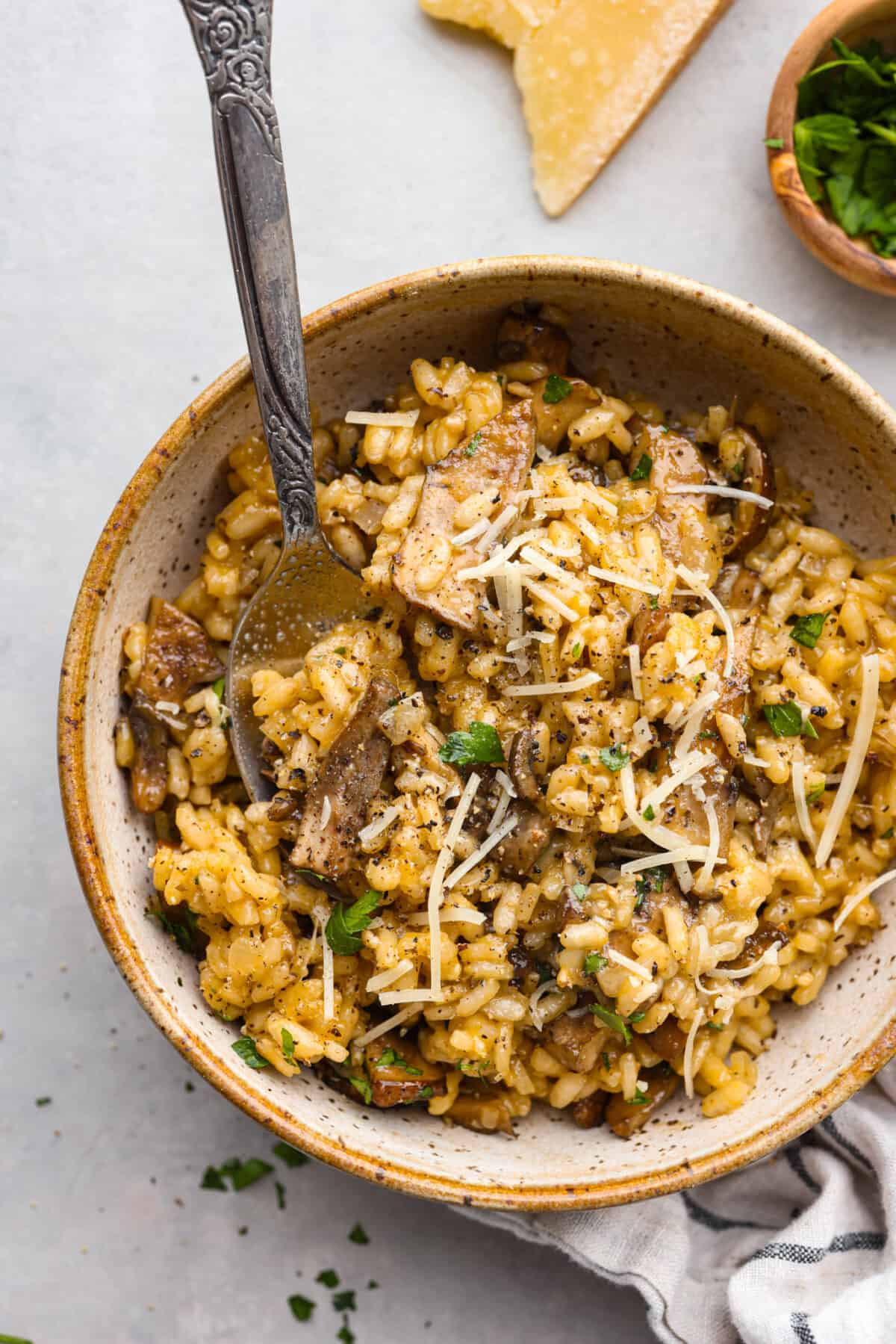 A serving of risotto in a stoneware bowl.