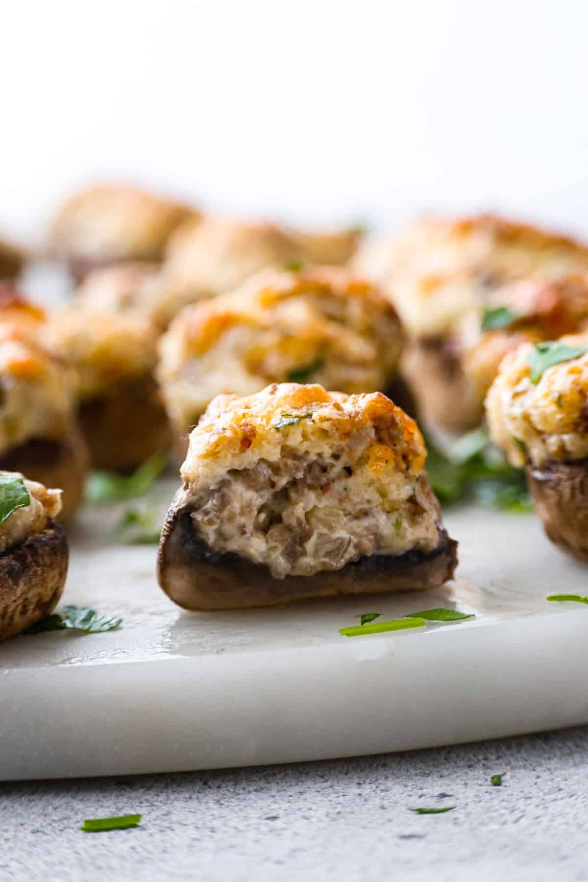 A sausage stuffed mushroom cut in half.