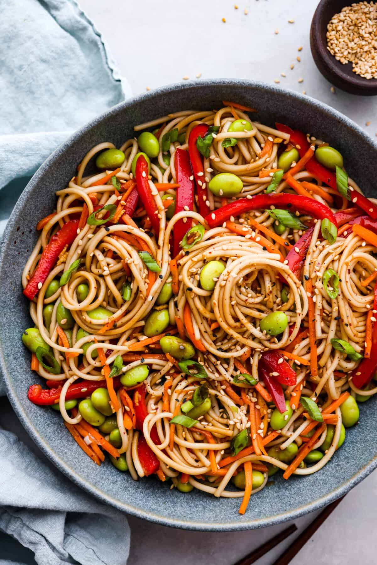 Top-down view of soba noodle salad in a large gray serving bowl.