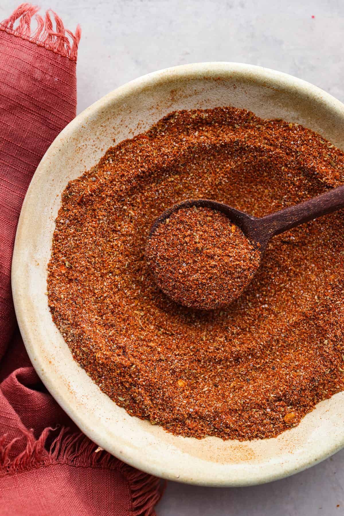 Close overhead view of Southwest seasoning mixed in a bowl with a wood spoon.