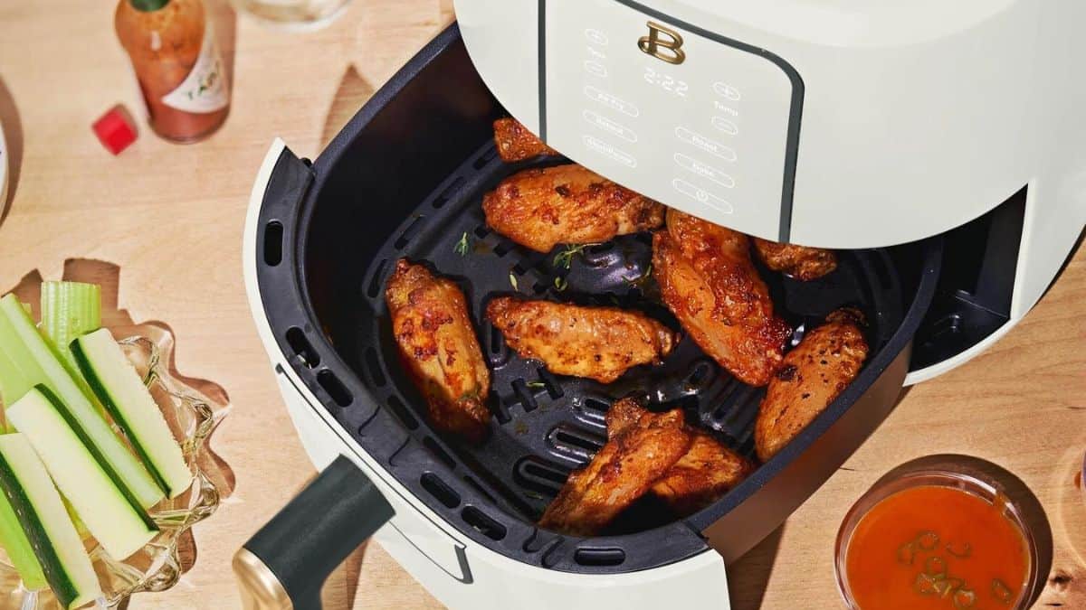 Wings in an air fryer basket. 