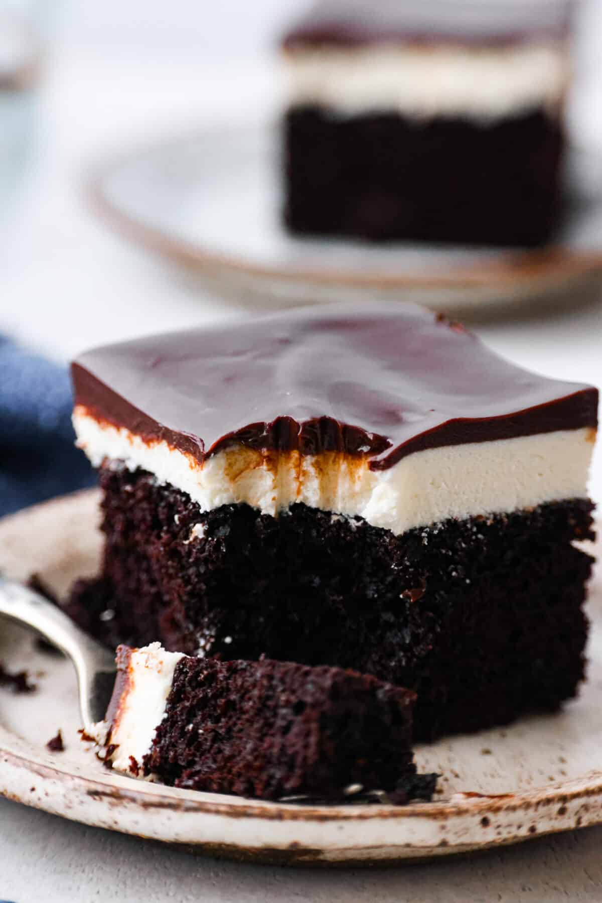 Close view of a fork on a plate with a slice of ho ho cake.