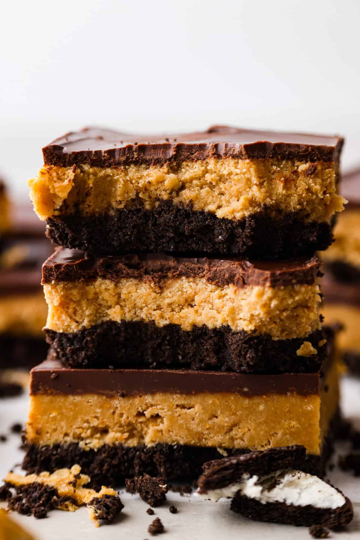 Side shot of a stack of Oreo peanut butter bars with some bites taken out. 