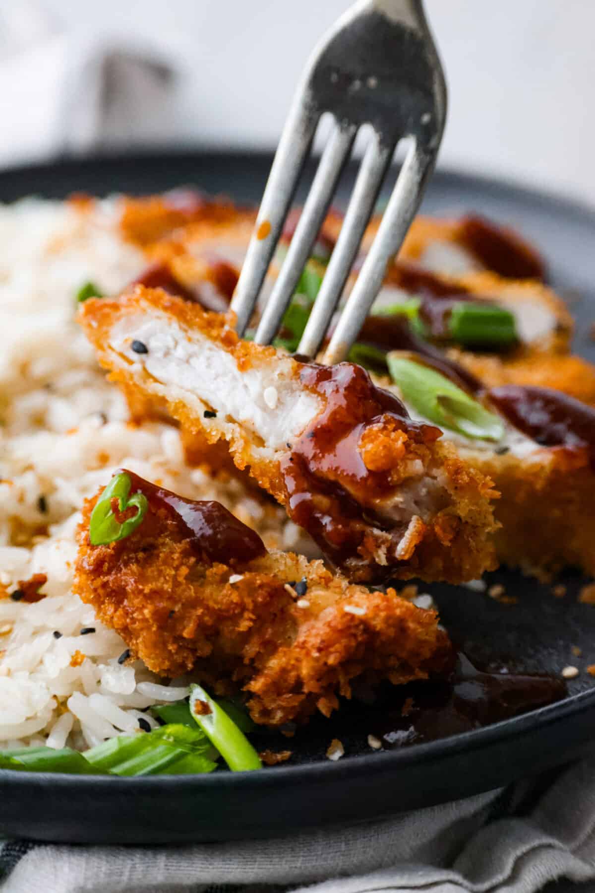 Closeup of a slice of pork katsu.