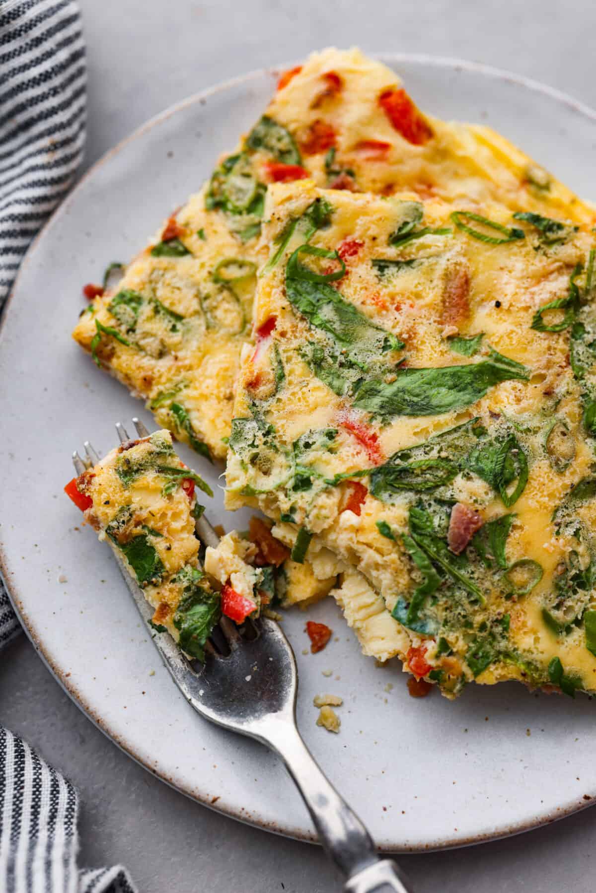 2 servings of sheet pan eggs on a white plate.