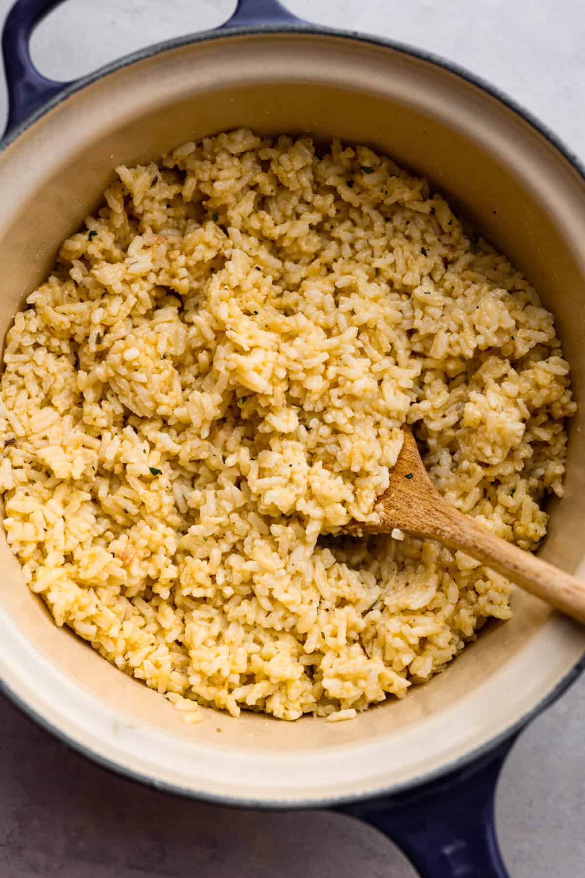 Souper rice cooked and ready to eat  in a pot with a wooden spoon. 