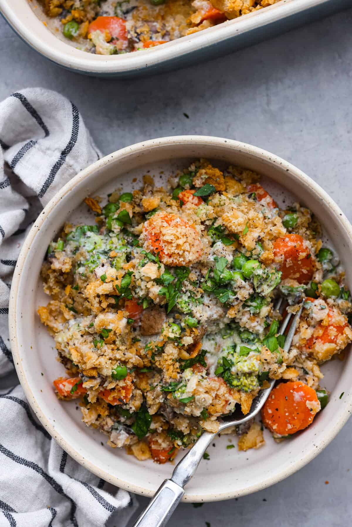 A serving of casserole in a white bowl.