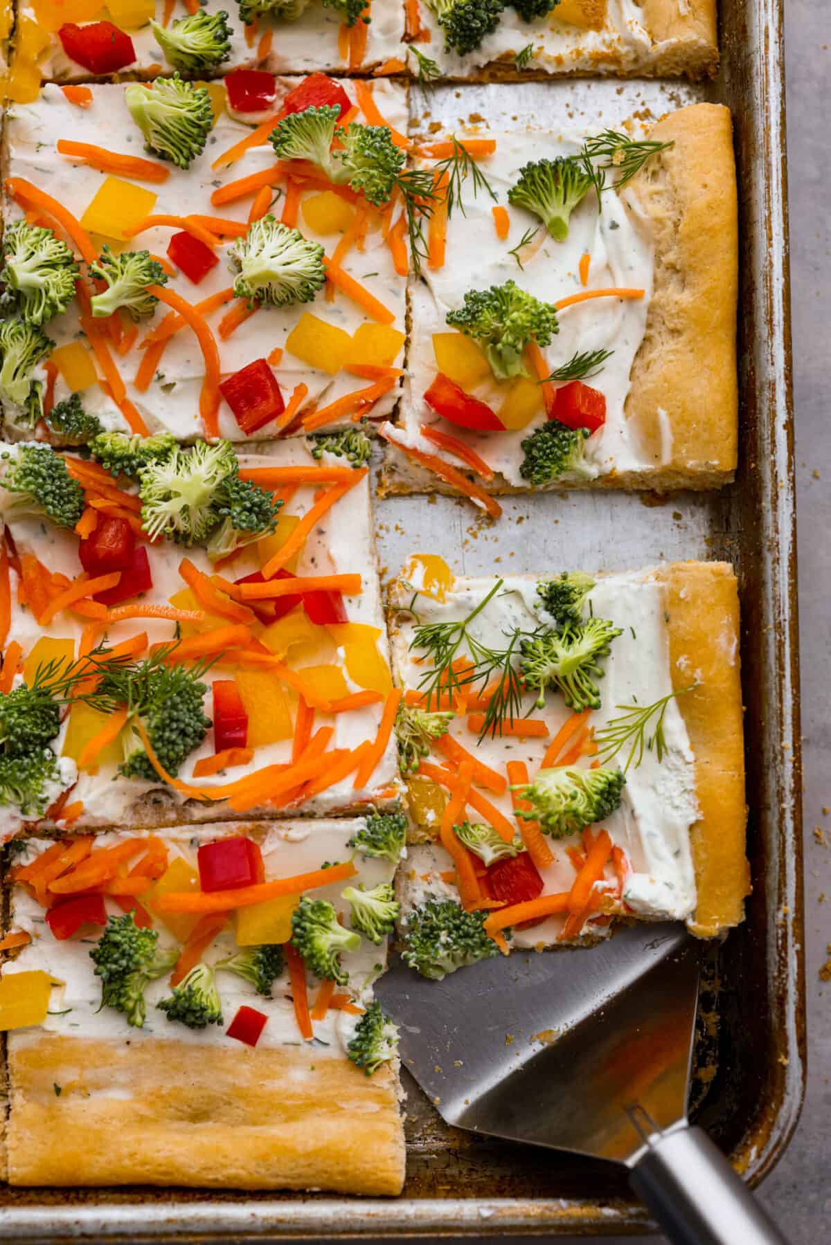 Top-down view of a vegetable pizza, cut into slices.