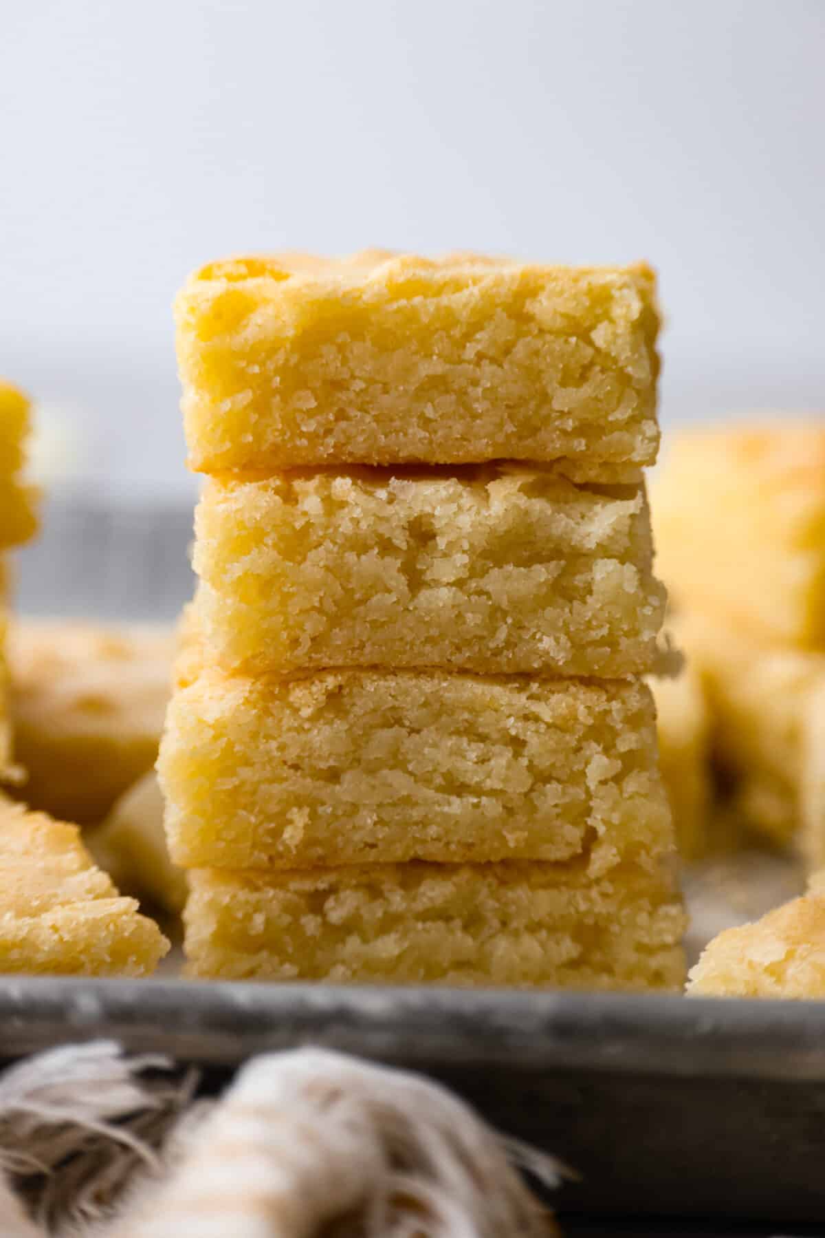 4 white chocolate brownies stacked on top of each other.