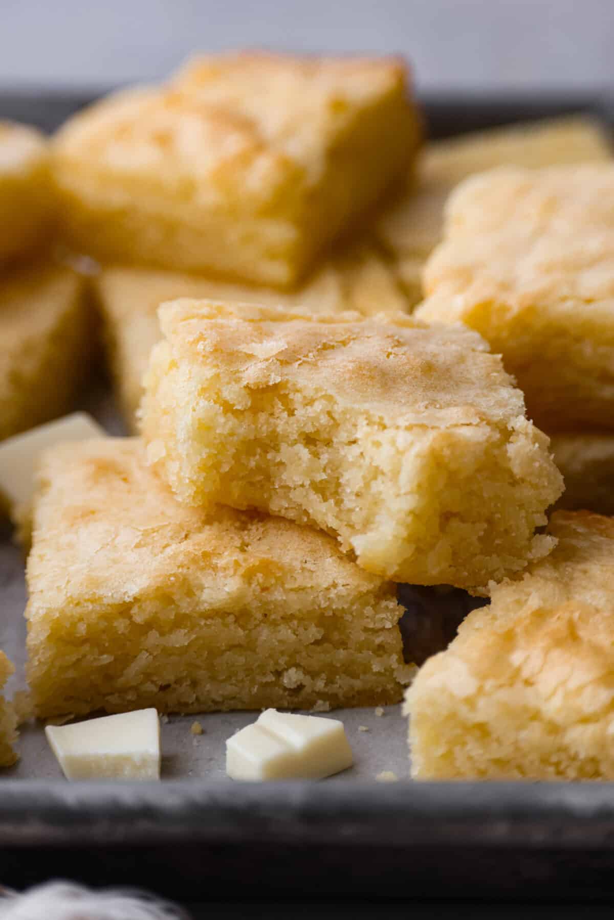 Closeup of a white chocolate brownie with a bite taken out of it.