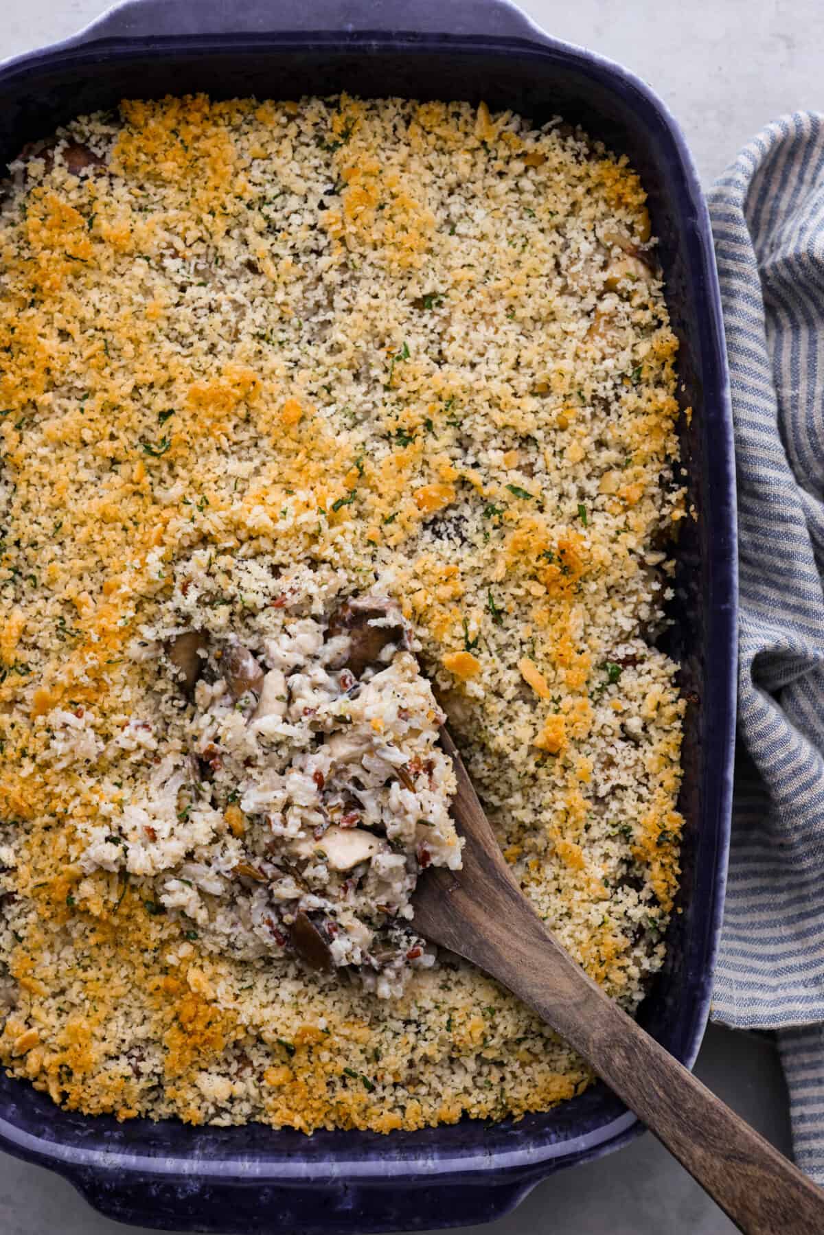 Top-down view of chicken and wild rice casserole in a black baking dish.