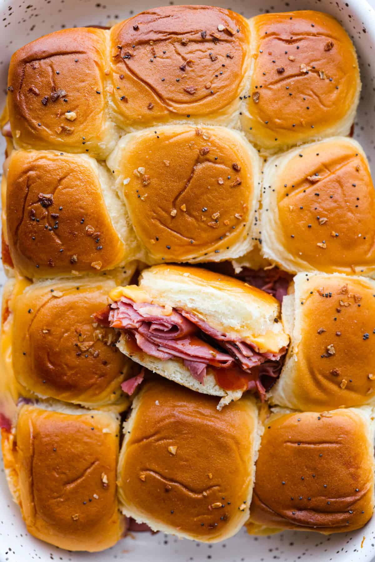 Top-down view of Arby’s copycat beef and cheddar sliders in a baking dish.