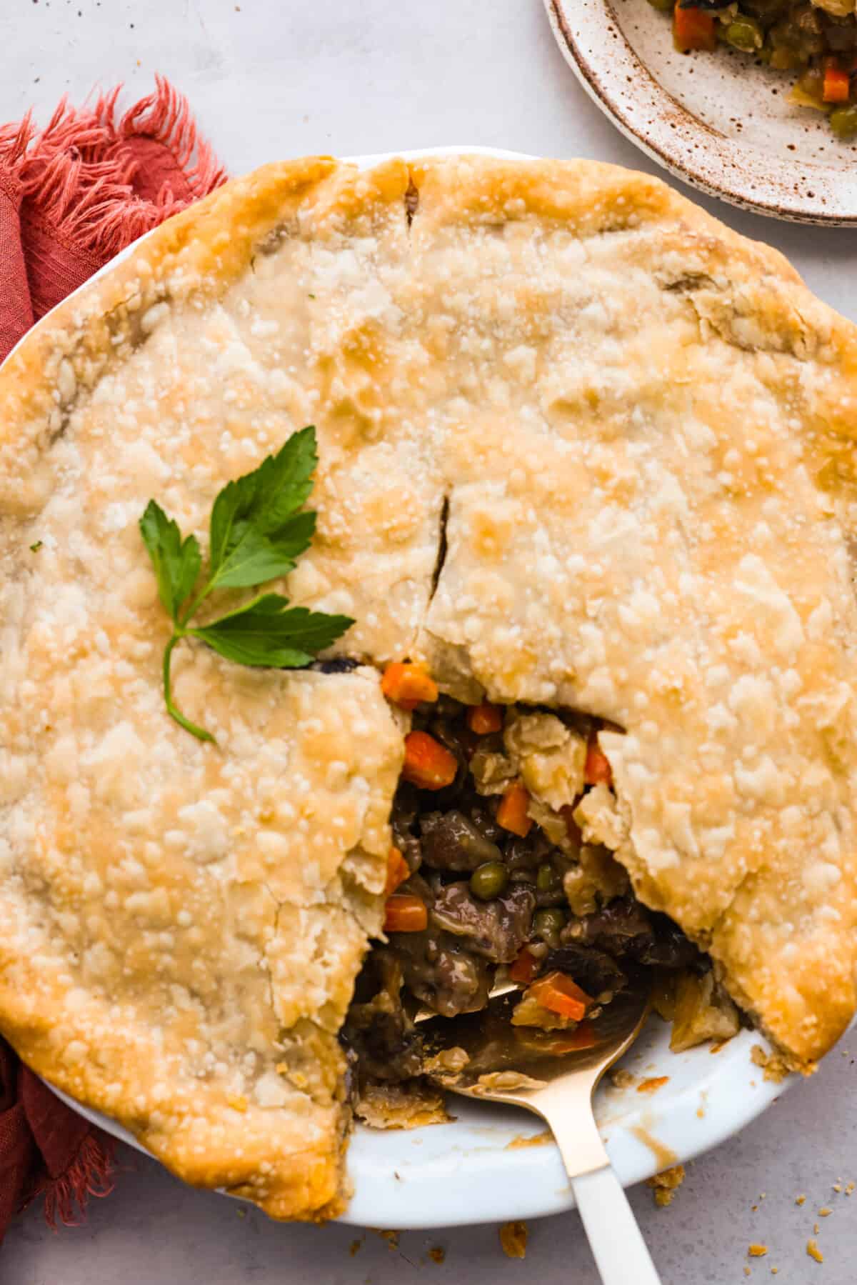 Top-down view of beef pot pie with a slice taken out of it.