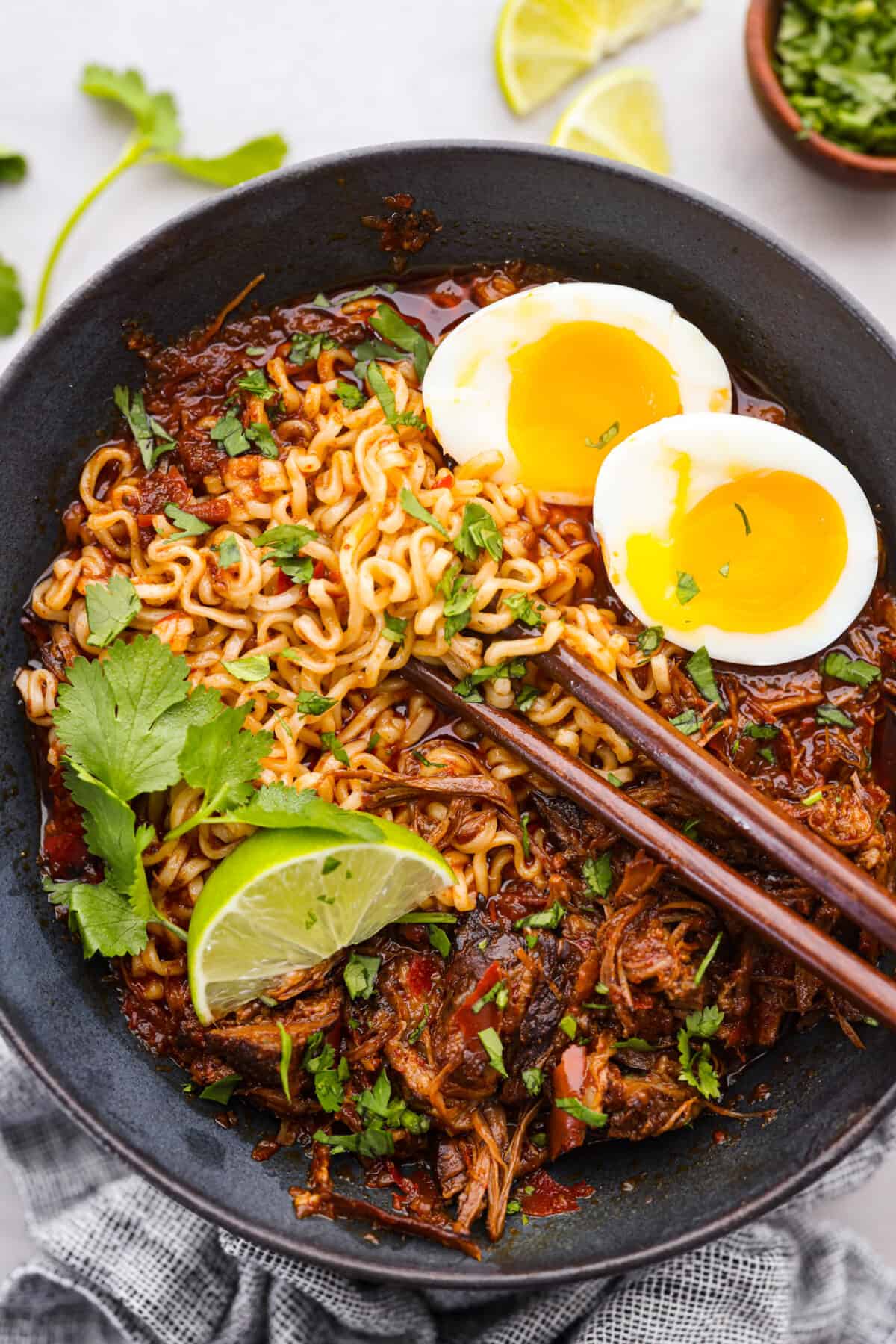 Shredded birria meat served with noodles and a rich broth.