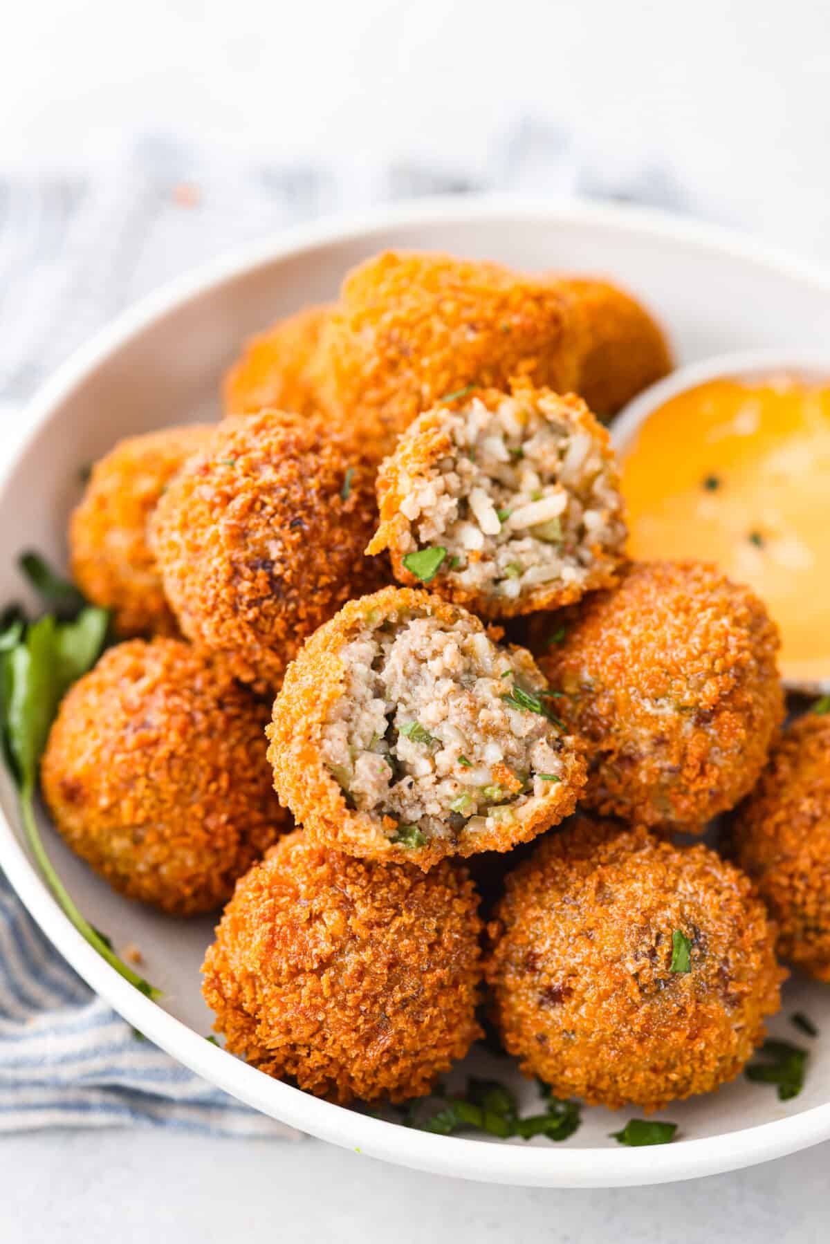 close up shot of fried boudin balls on a serving plate.