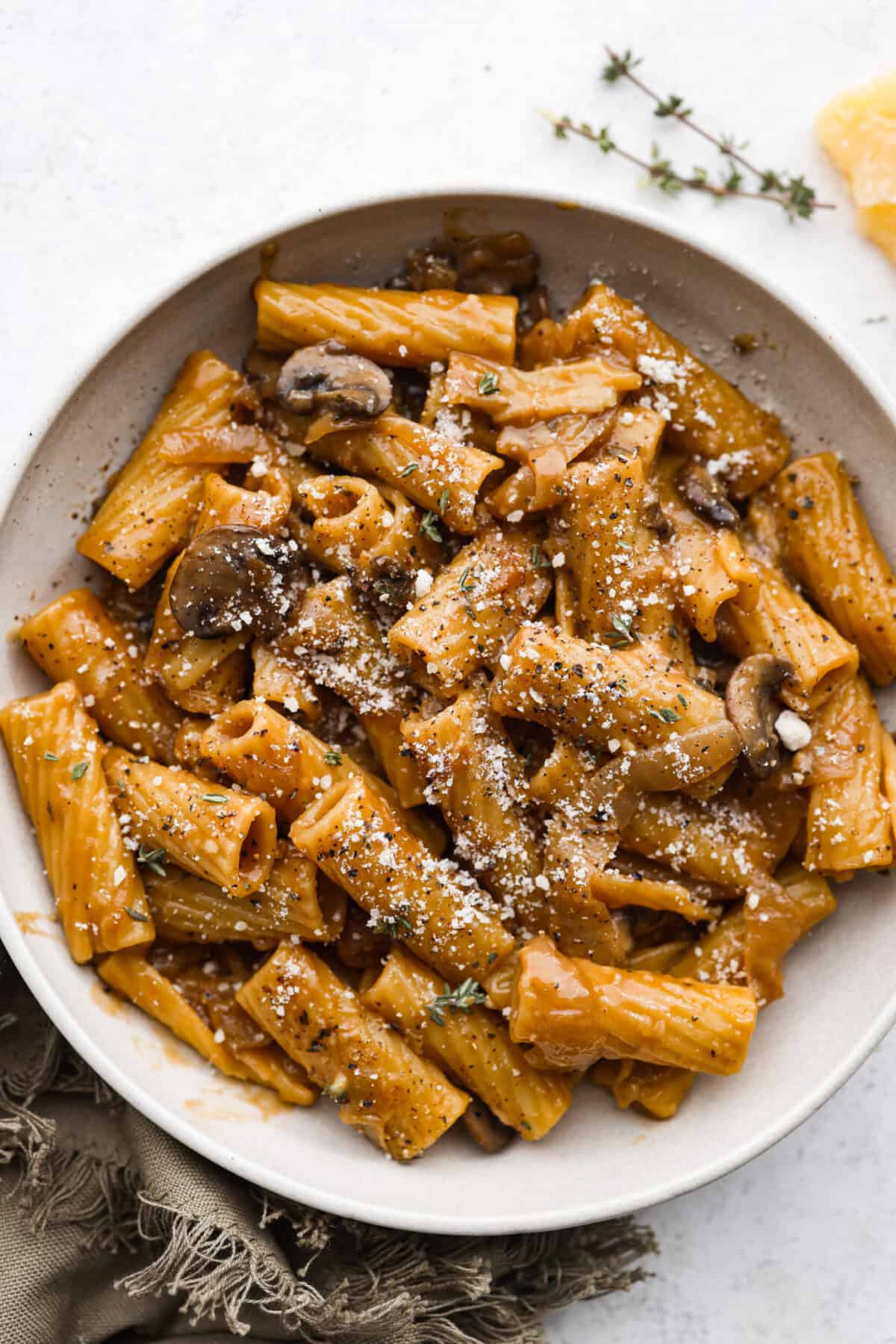 French onion pasta in a white bowl.