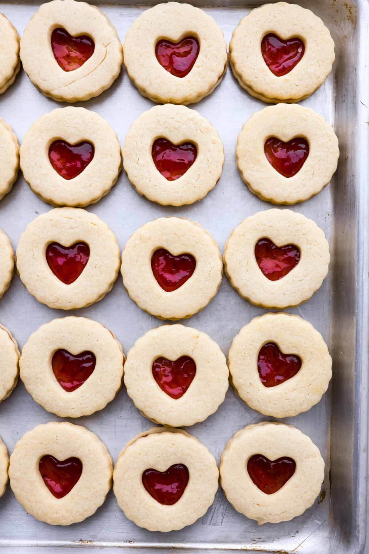 Top-down view of jammie dodgers in a baking sheet.