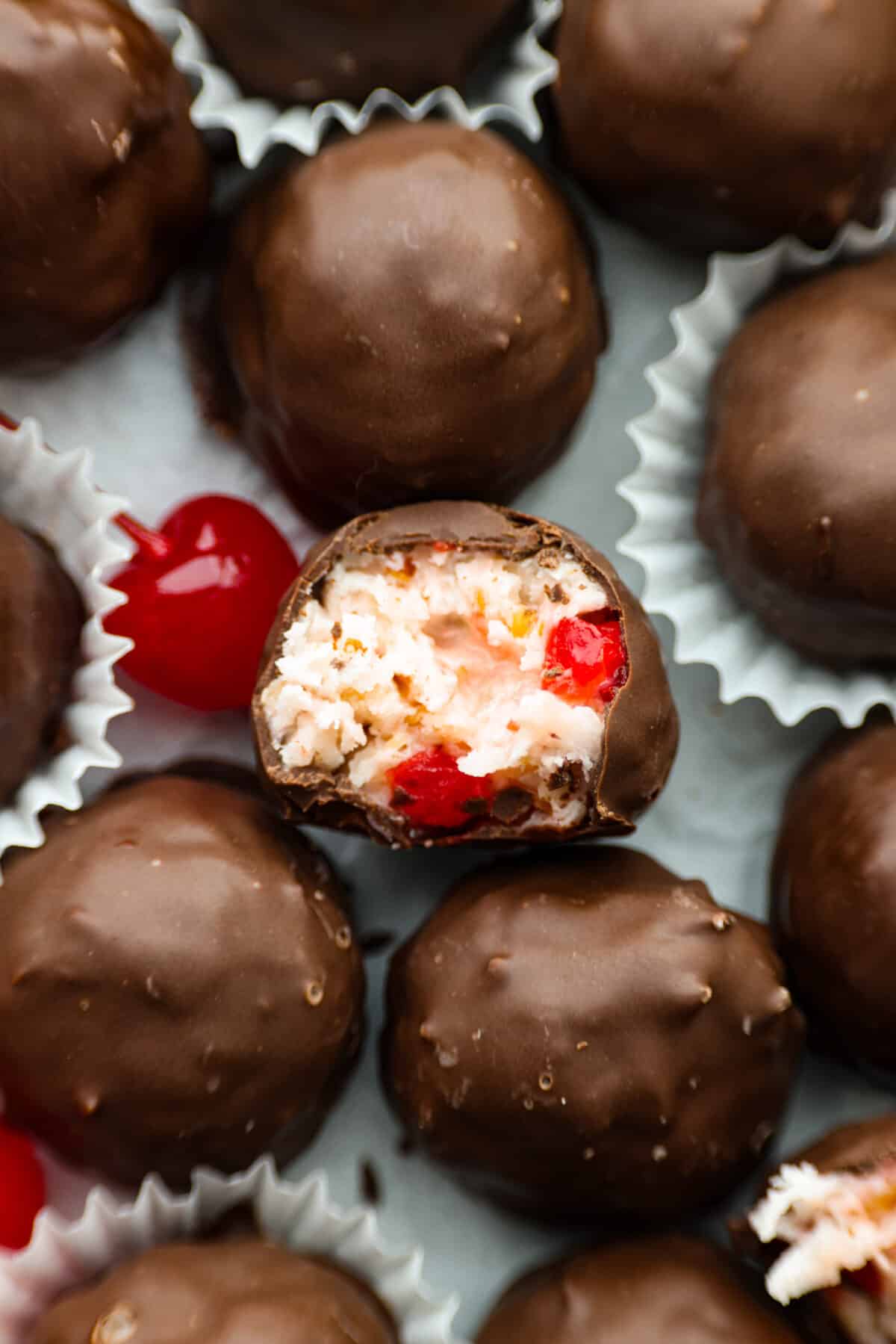 Closeup of Martha Washington Candy, with a bite taken out of it so the cherry filling can be seen.