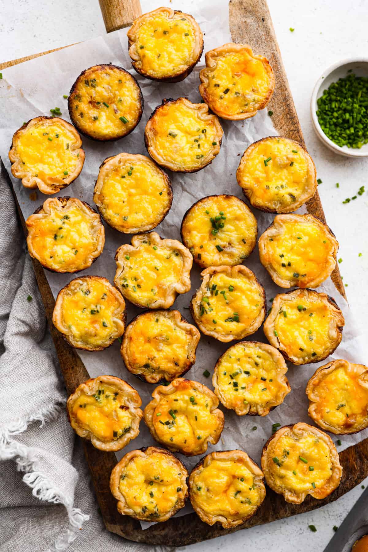 Cooked egg bites on a wooden serving board.