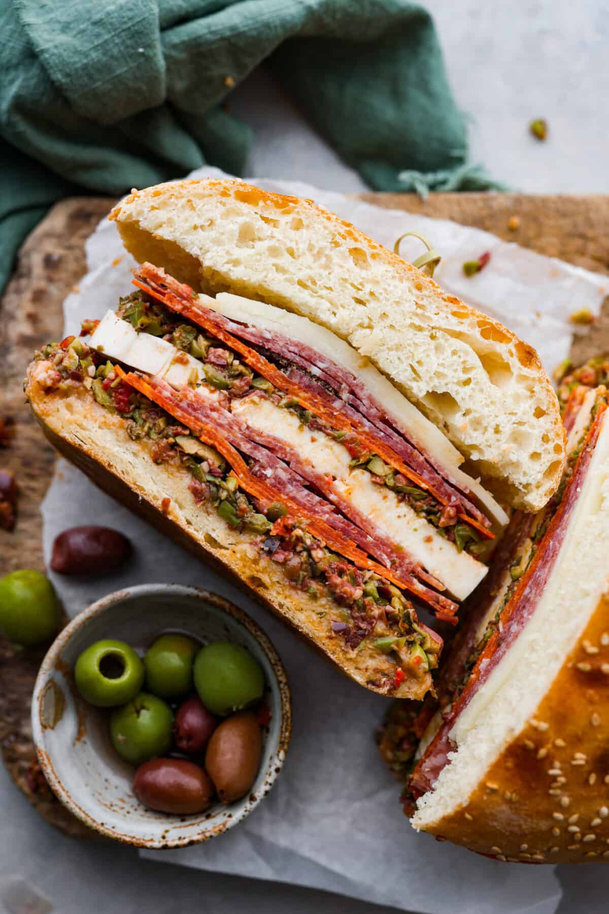 One half of a muffuletta sandwich. The meat and cheese filling can be seen.