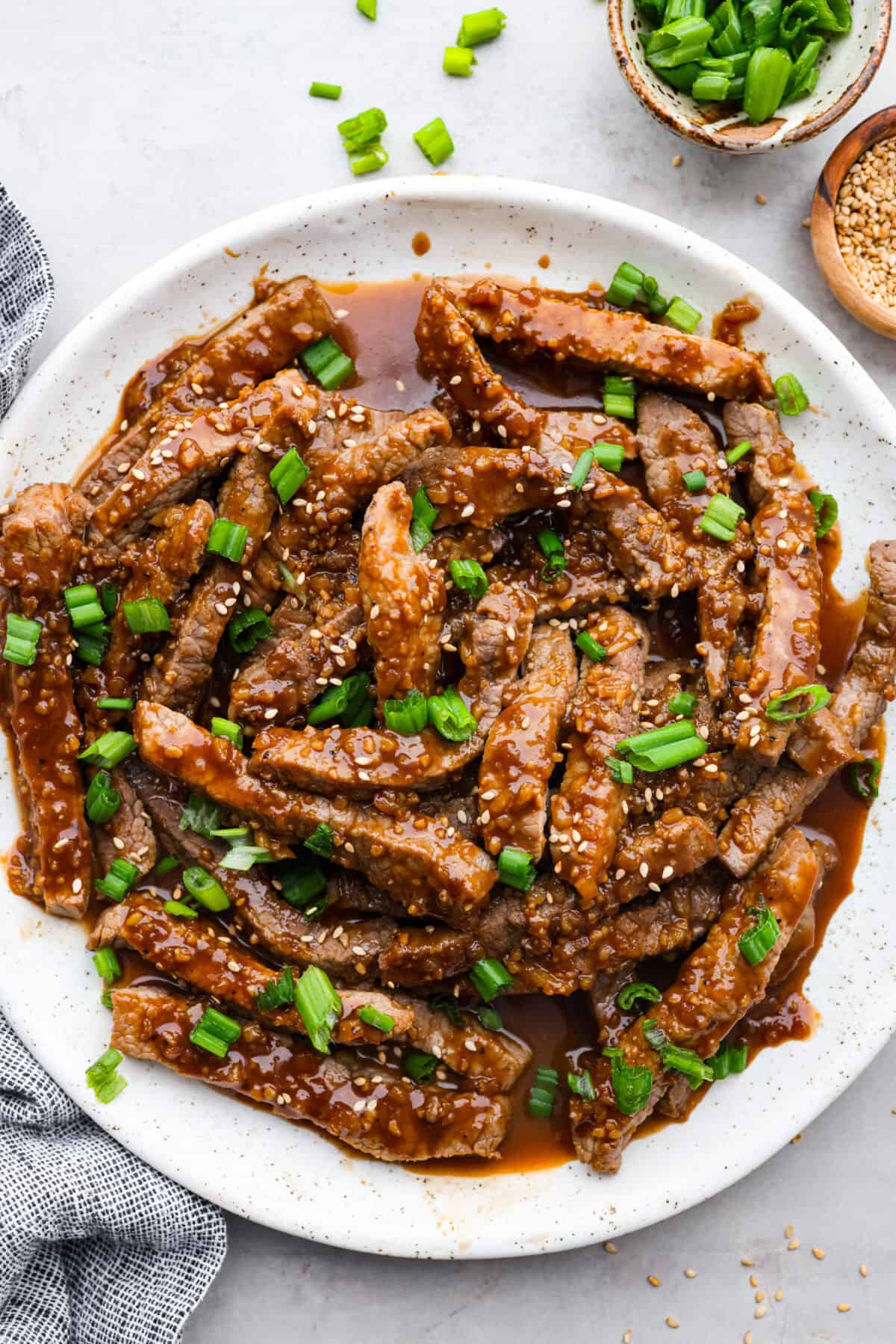 Strips of beef bulgogi served on a white plate.