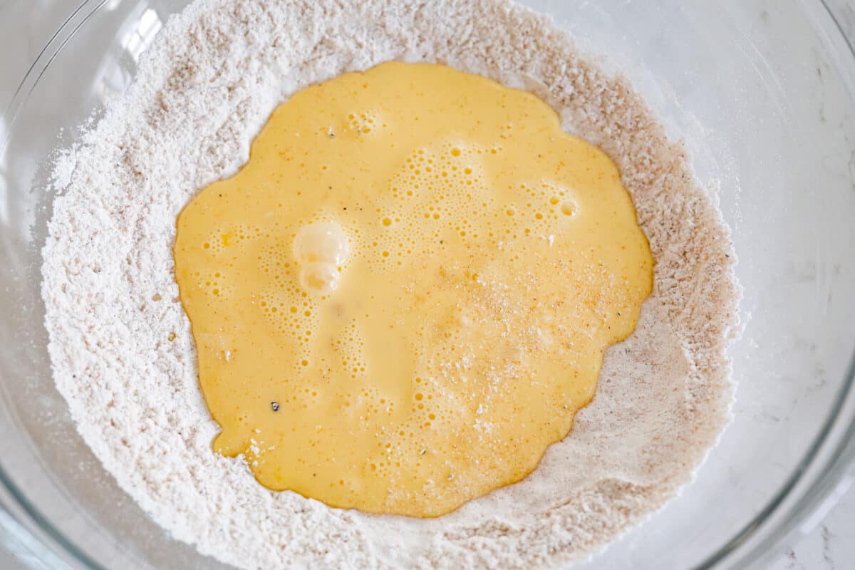 The egg mixture and flour mixture being combined