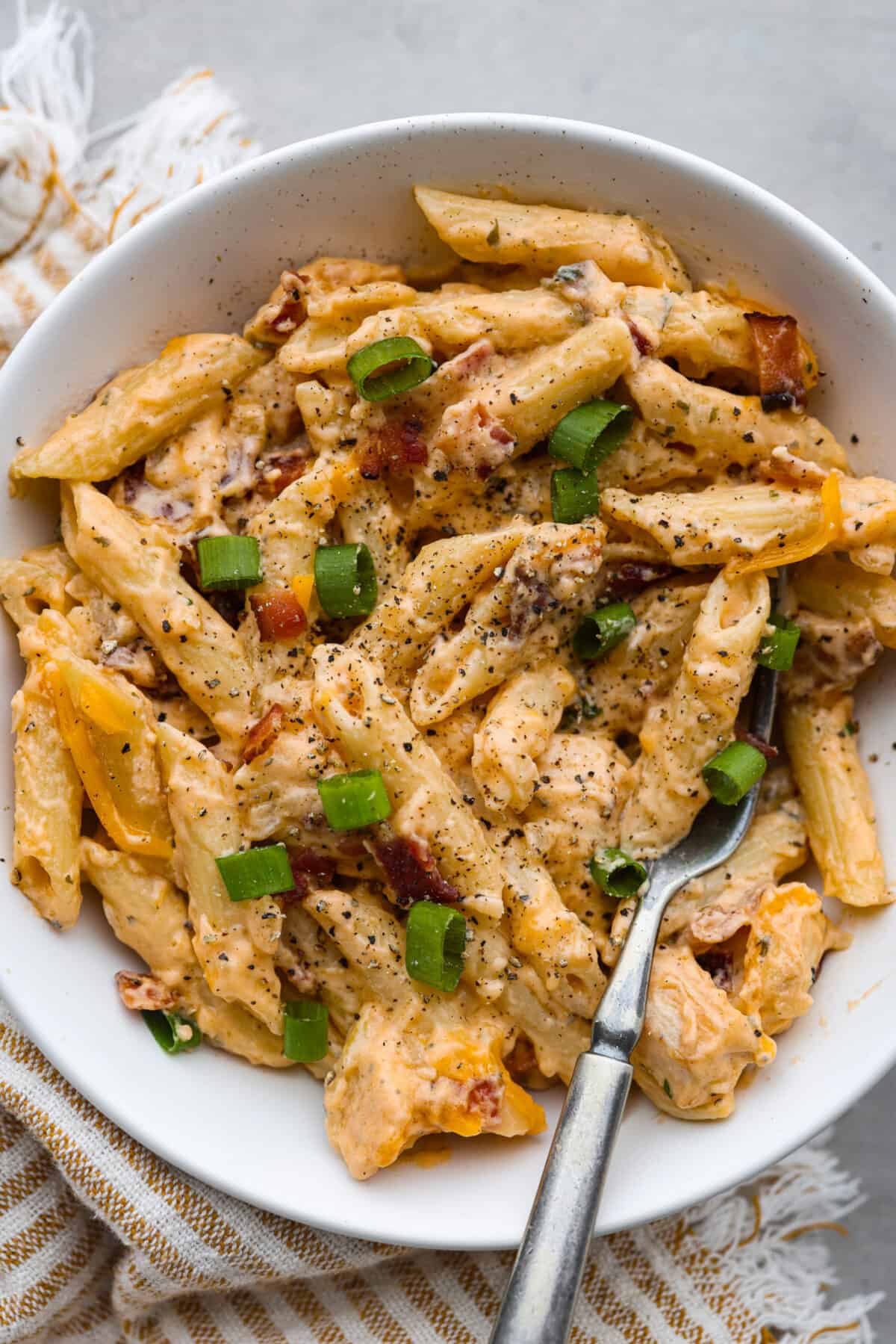 A serving of crack chicken pasta in a white bowl.