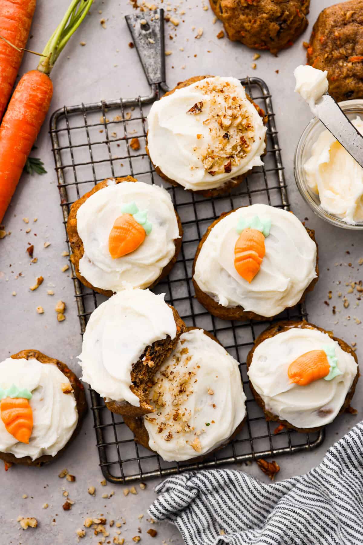 Frosted carrot cake cookies on a wire rack.