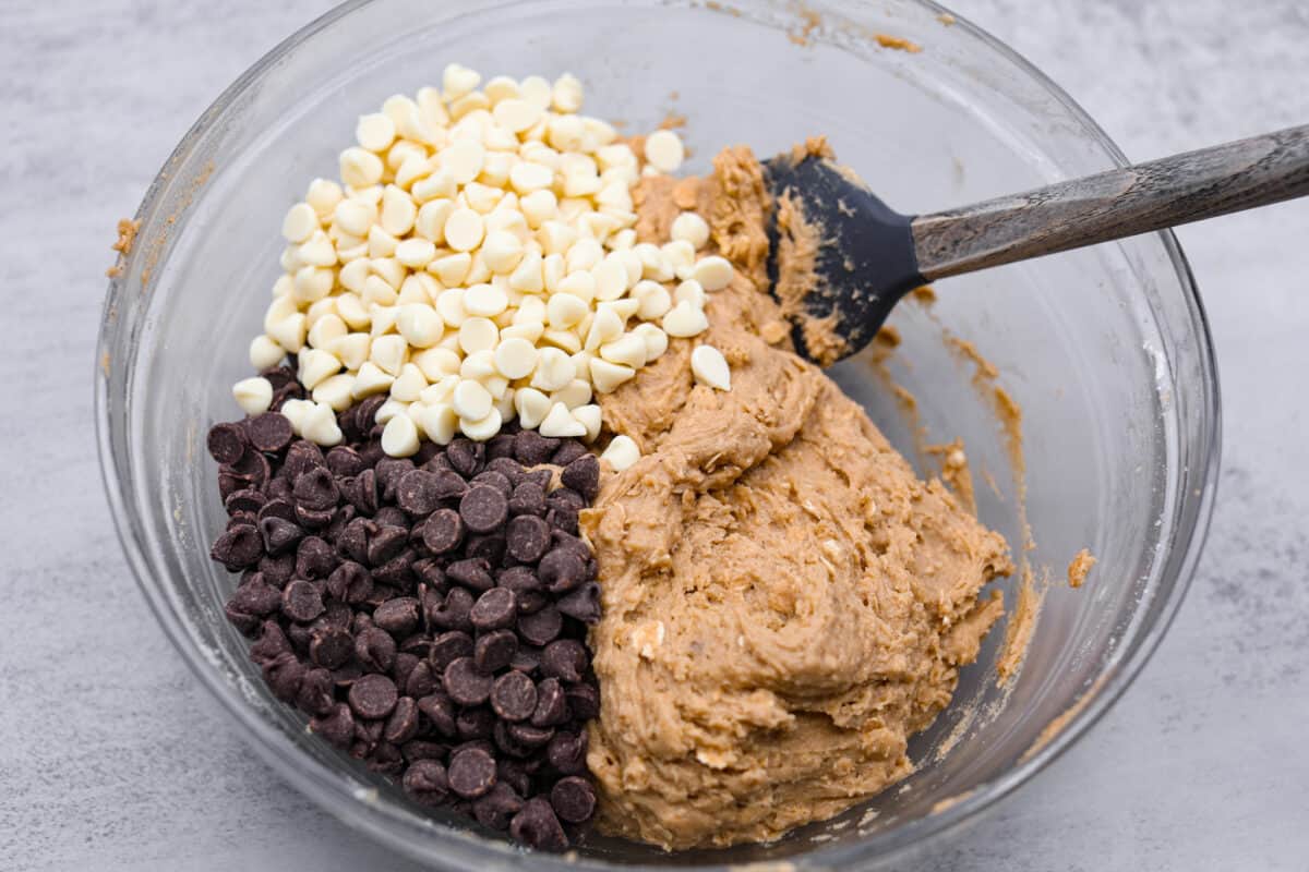 The white and semi-sweet chocolate chips being folded in.