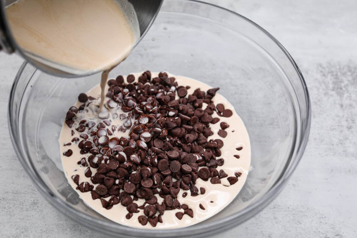 Adding chocolate chips into the frosting mixture 