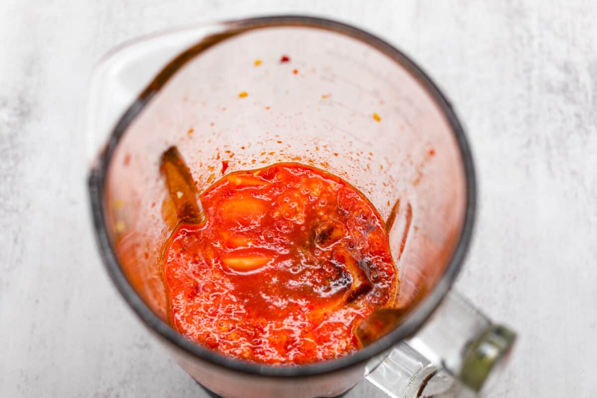 The blended chiles in the bottom of a measuring cup.