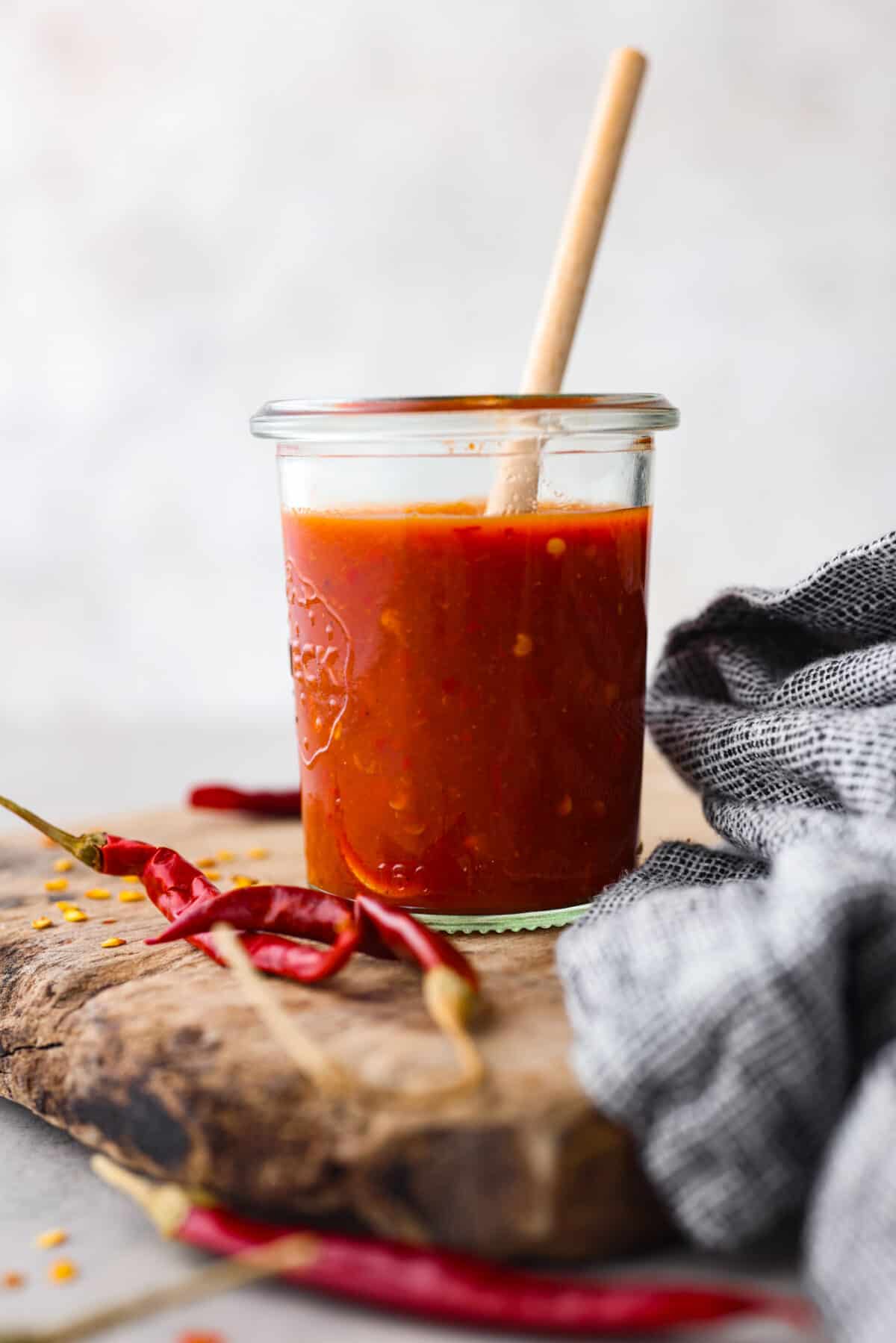 Homemade hot sauce in a glass jar.