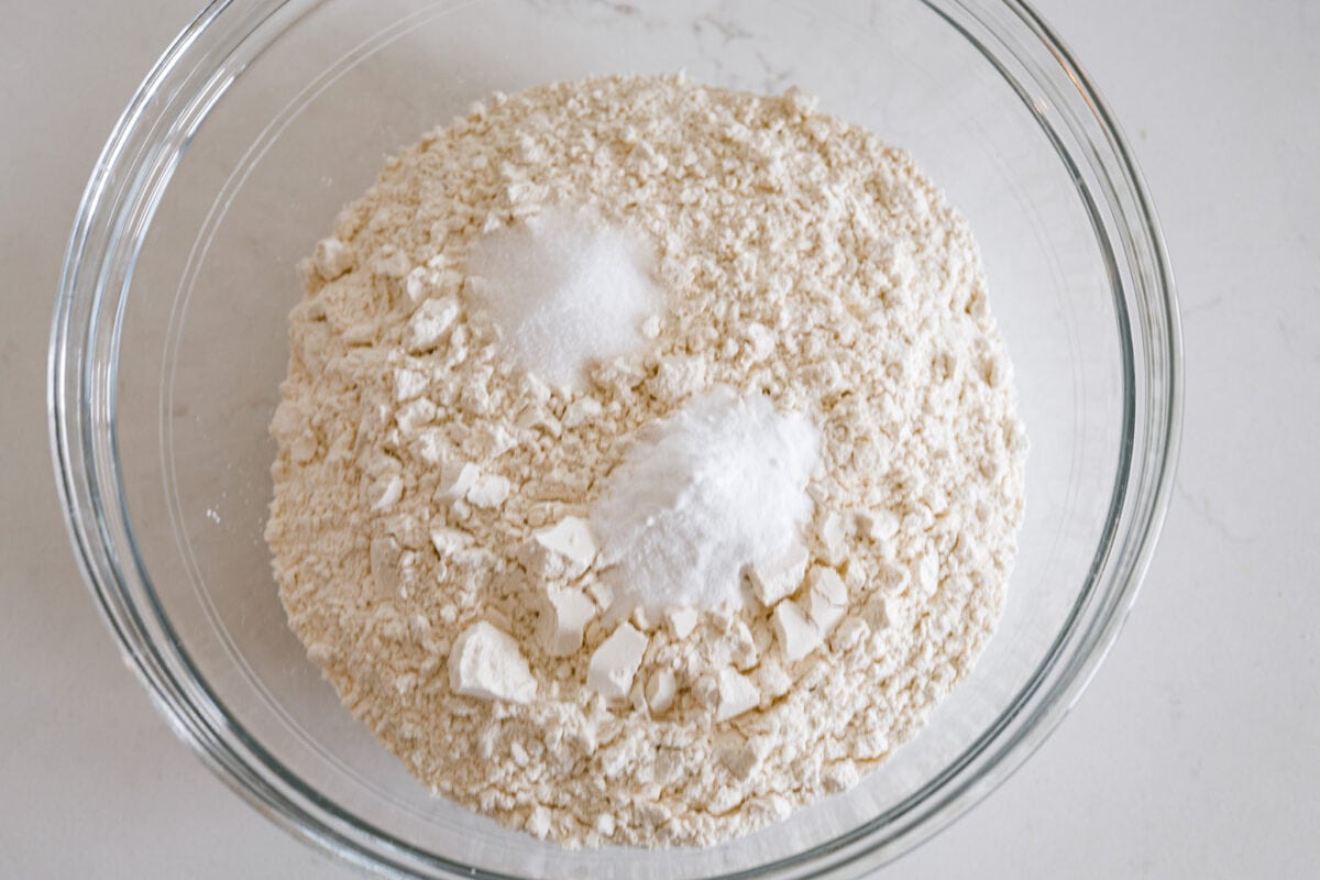 Soda bread dough ingredients in a glass bowl.