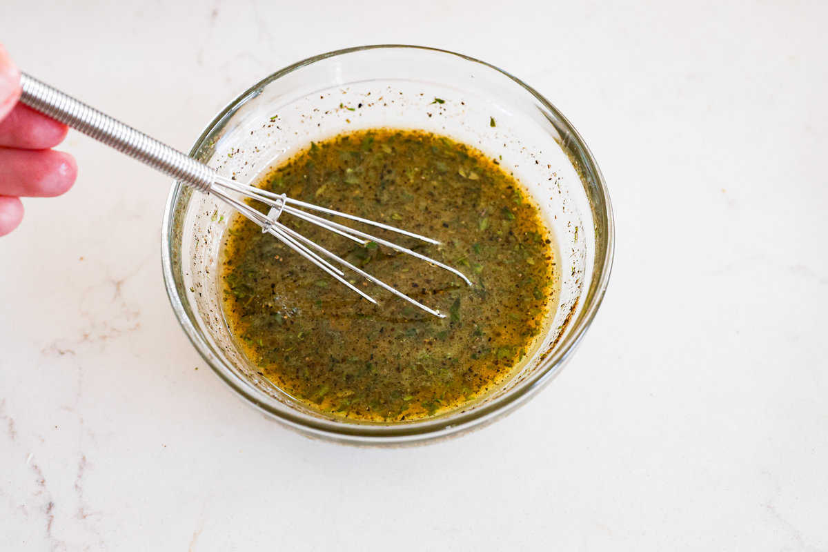 Whisking the tamarind cashew dipping sauce to ensure a smooth consistency.