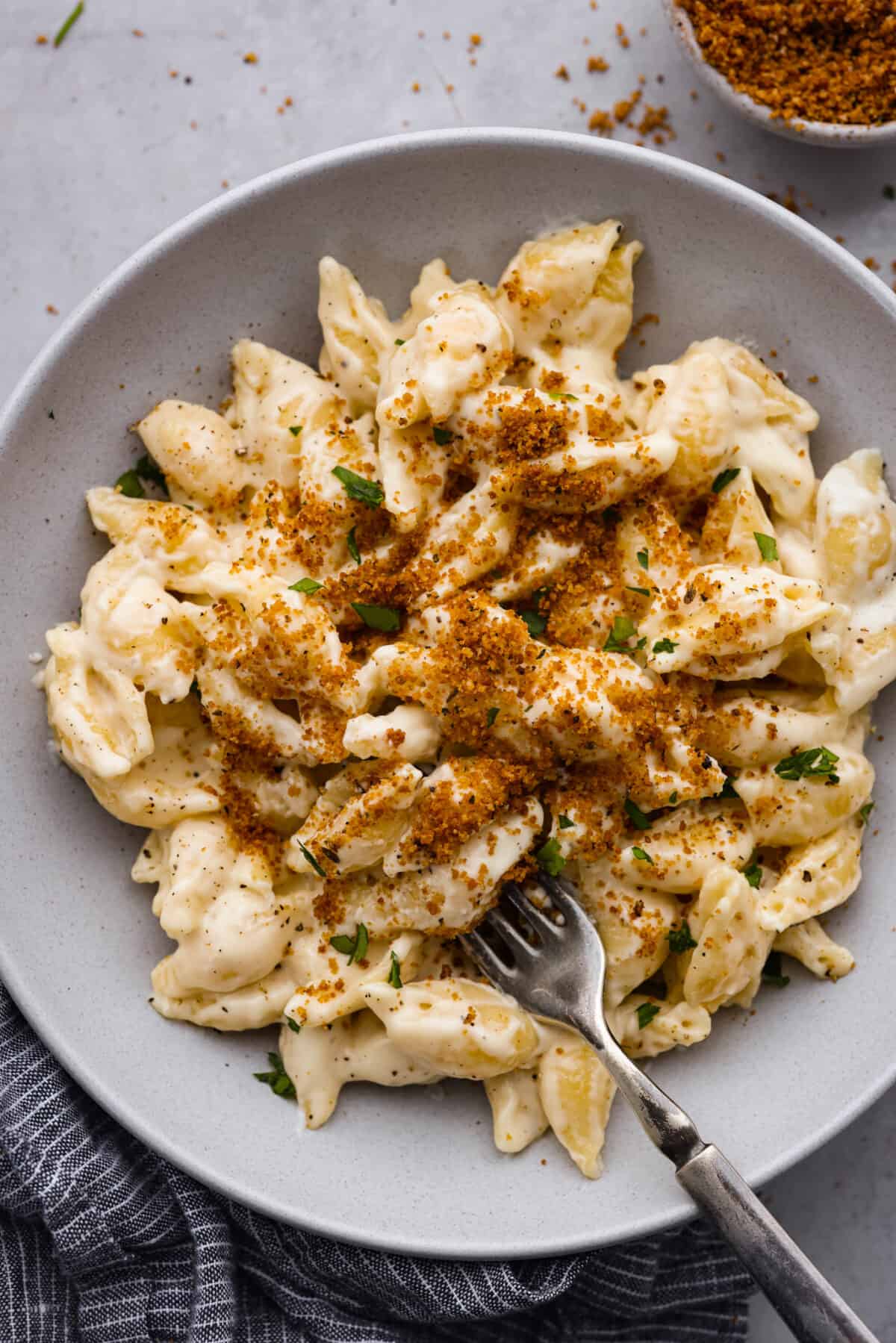 A serving of mac and cheese, topped with breadcrumbs.