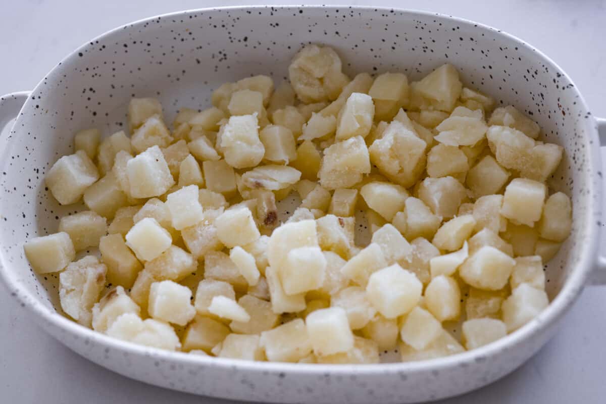 The hash browns acting as the base layer of the Big Mac casserole.