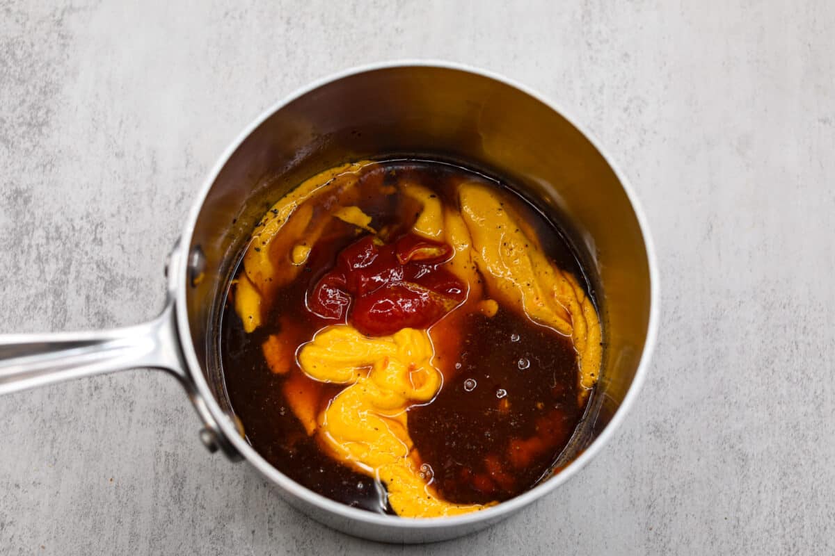 Adding all of the ingredients to a saucepan.