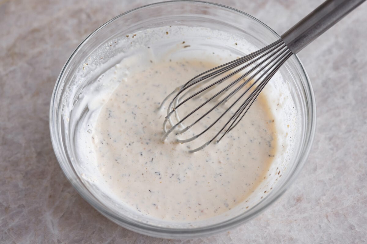 Whisking up the dressing for the grinder salad