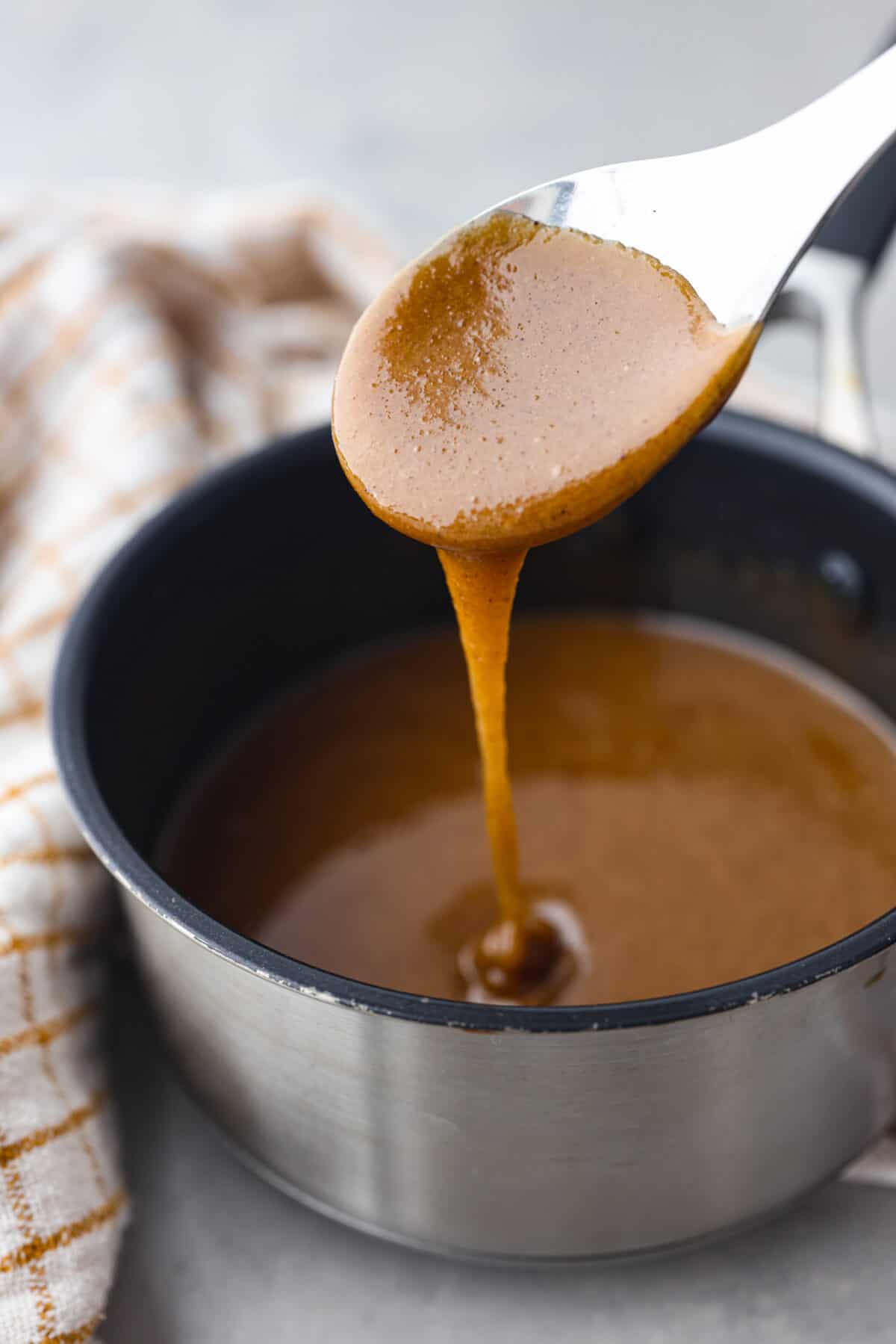 The glaze dripping off a metal spoon.