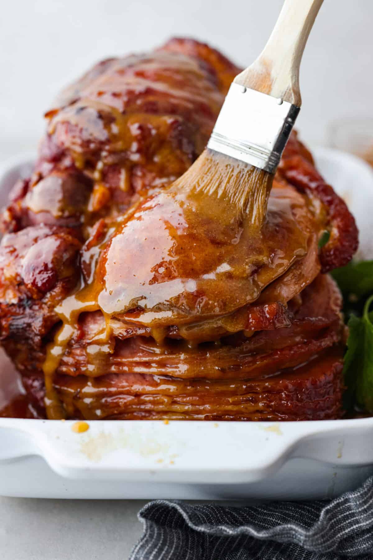 Basting the glaze over a spiral cut ham.