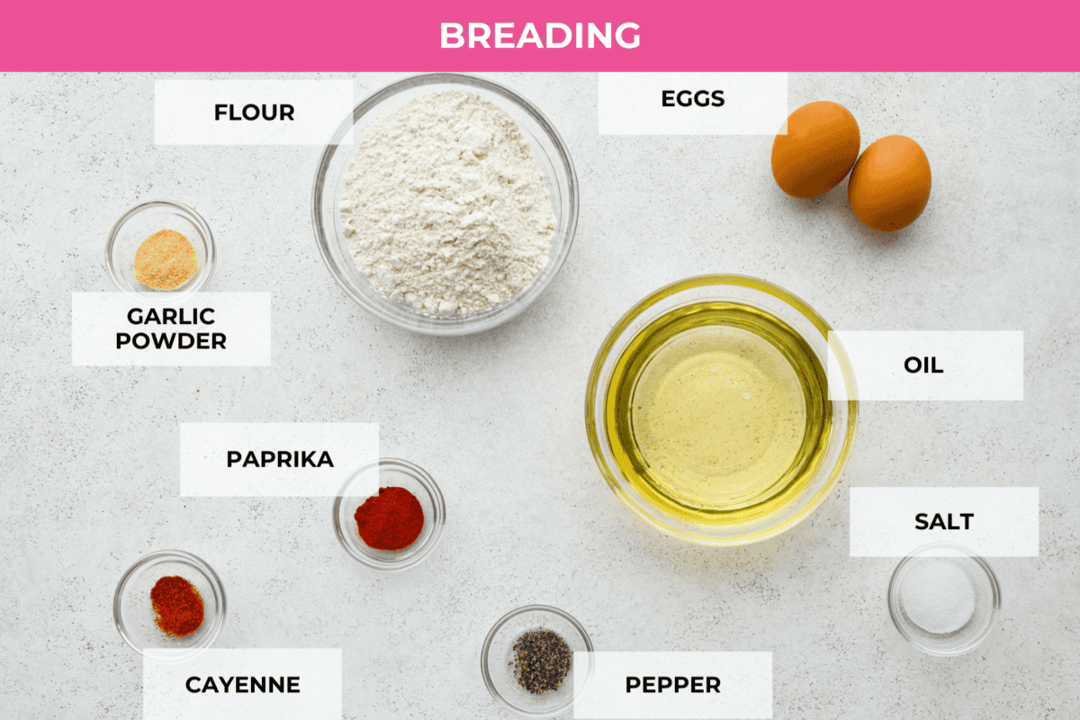 All of the ingredients for the country fried chicken breading. Listed are: garlic powder, flour, eggs, paprika, cayenne, salt, pepper, and oil.