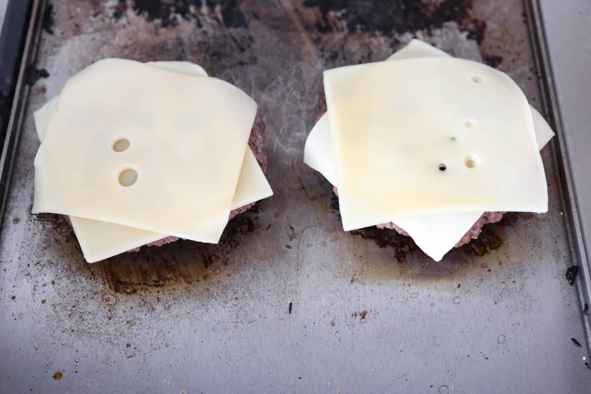 Cheese added to the top of the patties. 