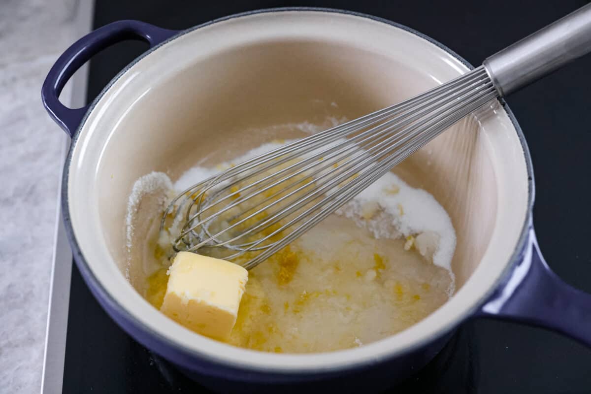 First photo of butter, sugar, lemon juice and zest in a saucepan.